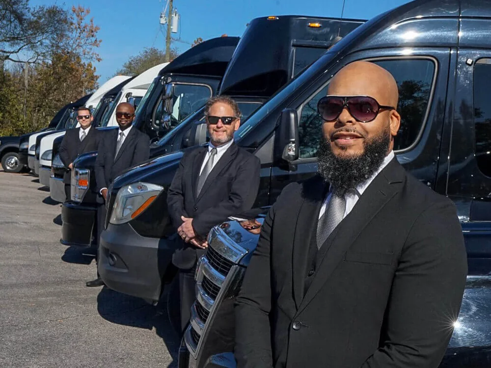 Signature Transportation Services chauffeurs standing with the Nashville fleet